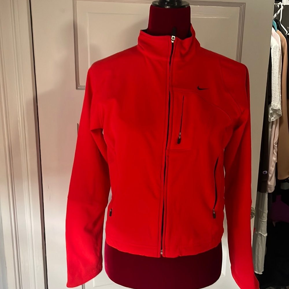 Woman’s red Nike track jacket